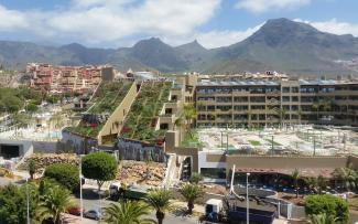 Large building with steep pitched green roof