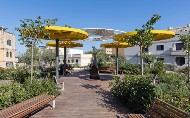 Roof garden with wooden podium and yellow canopies